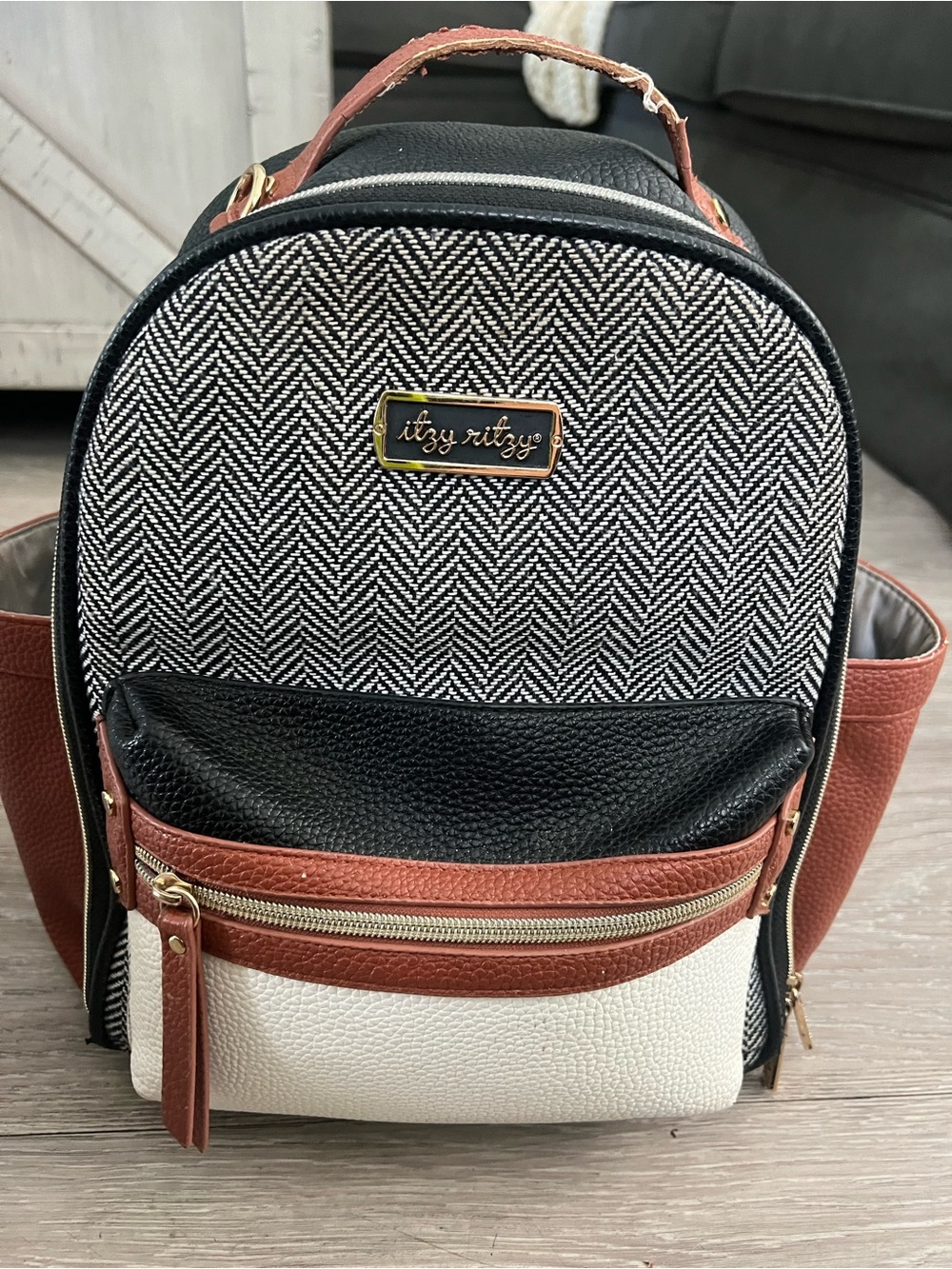 Itzy Ritzy Mini Backpack diaper bag in Navy, cream & saddle Trim